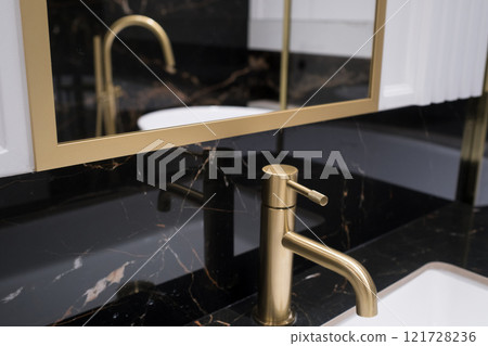 Bronze water faucet and white pedestal sink in bathroom. Stylish bathroom Bronze water faucet and white pedestal sink in bathroom. Stylish bathroom 121728236