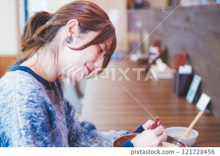 快樂的年輕女人吃美味的拉麵 快樂的年輕女人吃美味的拉麵 121728456
