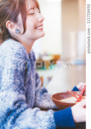 A young woman groans at the deliciousness A young woman groans at the deliciousness 121728458