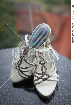 Stylish and highly fashionable woman high heeled shoes with trendy accessories, captured on a colorful background, exuding luxury and elegance perfect for wedding or formal outfit inspiration Stylish and highly fashionable woman high heeled shoes with trendy accessories, captured on a colorful background, exuding luxury and elegance perfect for wedding or formal outfit inspiration 121728581