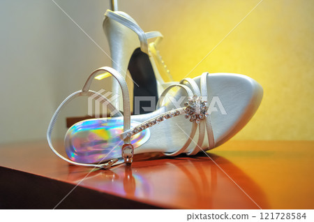 Stylish and highly fashionable woman high heeled shoes with trendy accessories, captured on a colorful background, exuding luxury and elegance perfect for wedding or formal outfit inspiration Stylish and highly fashionable woman high heeled shoes with trendy accessories, captured on a colorful background, exuding luxury and elegance perfect for wedding or formal outfit inspiration 121728584
