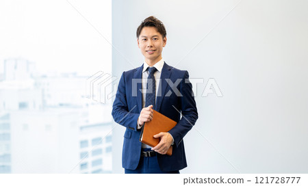 Male businessman with a binder Male businessman with a binder 121728777