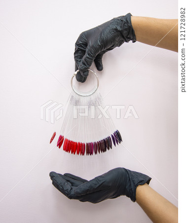 Multicolor different palette gel varnishes examples for manicure in hand selective focus Multicolor different palette gel varnishes examples for manicure in hand selective focus 121728982