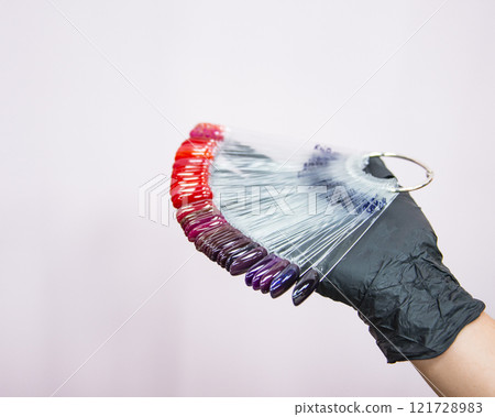Multicolor different palette gel varnishes examples for manicure in hand selective focus 121728983