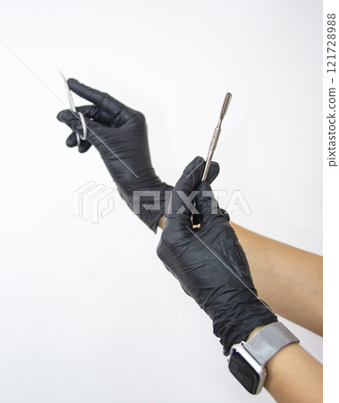 Beauty salon nails content black gloves on woman hand Beauty salon nails content black gloves on woman hand 121728988