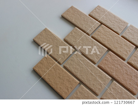 Facing tiles imitating the surface of bricks on a white surface angle view stock photo Facing tiles imitating the surface of bricks on a white surface angle view stock photo 121730667