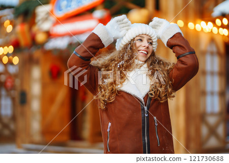 Happy woman posing at a festive street market. Holiday concept, relaxation. 121730688