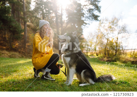 Happy female posing outdoors with her dog. Concept of friendship, vacation, walk. Happy female posing outdoors with her dog. Concept of friendship, vacation, walk. 121730923