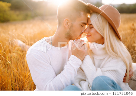 Young couple having fun walking and hugging n the park. Autumn weather. Relaxation, youth. Young couple having fun walking and hugging n the park. Autumn weather. Relaxation, youth. 121731046