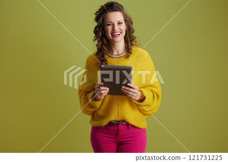 happy healthy woman using tablet PC isolated on green happy healthy woman using tablet PC isolated on green 121731225