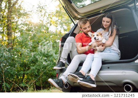 Portrait of caring, loving couple with their dog in back seat of car while traveling. Pet and human. Portrait of caring, loving couple with their dog in back seat of car while traveling. Pet and human. 121731245