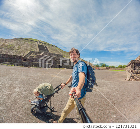 Dad and his son tourists exploring Teotihuacan, Mexico. Solo traveler walking through ancient pyramids and ruins at sunrise. Concept of cultural heritage, archaeology, and Mexican tourism 121731321