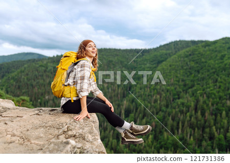 Traveler observes mountain scenery from cliff, view of European troll tongue. Concept of freedom. Traveler observes mountain scenery from cliff, view of European troll tongue. Concept of freedom. 121731386