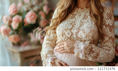 Beautiful pregnant woman in a rustic setting, embracing her belly, surrounded by natural decor 121731476