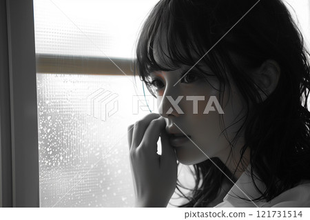 Profile of a woman quietly worrying by the window on a rainy day 121731514