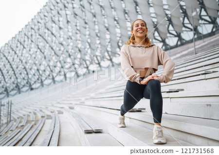 Young woman in sportswear is training outdoors. Sports concept, healthy body. Young woman in sportswear is training outdoors. Sports concept, healthy body. 121731568