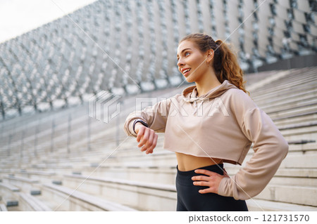 Young woman in sportswear is training outdoors. Sports concept, healthy body. Young woman in sportswear is training outdoors. Sports concept, healthy body. 121731570