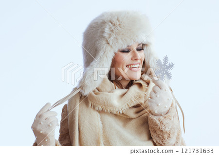 smiling stylish woman in winter coat and fur hat on white smiling stylish woman in winter coat and fur hat on white 121731633