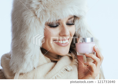 happy stylish woman in winter coat and fur hat on white 121731640