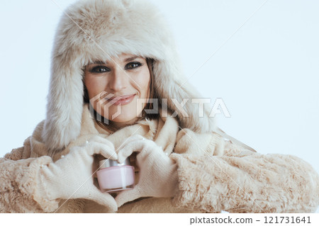 happy stylish woman in winter coat and fur hat on white 121731641