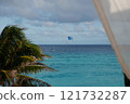 Experience a tropical paradise with thrilling parasailing over vibrant turquoise waters 121732287