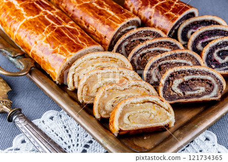 Traditional Hungarian Christmas cookies with poppy seed, walnut and almond on a copper serving tray Traditional Hungarian Christmas cookies with poppy seed, walnut and almond on a copper serving tray 121734365