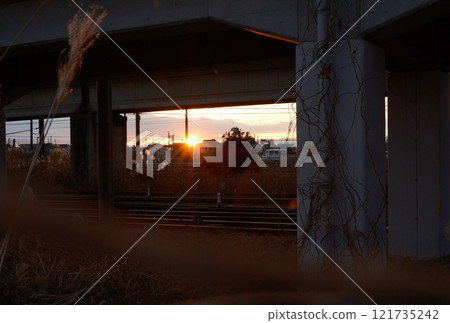 A rural townscape bathed in the setting sun seen from under the overpass A rural townscape bathed in the setting sun seen from under the overpass 121735242