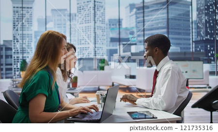 Human resources staff interviewing a male job candidate in office, reviewing his resume and discussing qualifications. Ensuring potential for career advancement within the company. Camera B. Human resources staff interviewing a male job candidate in office, reviewing his resume and discussing qualifications. Ensuring potential for career advancement within the company. Camera B. 121735316