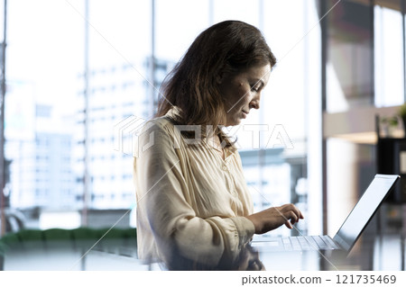 Female CEO leader working on financial planning and budget allocation, ensuring the company resources are used effectively to achieve maximum profit and long term objectives in office. 121735469
