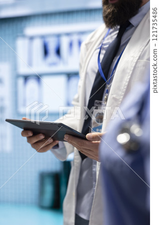 Medical experts team reviews x ray test results to find suitable treatment plan, private clinic meeting. Doctors doing teamwork for diagnostic control and analytics with radiography scans. Medical experts team reviews x ray test results to find suitable treatment plan, private clinic meeting. Doctors doing teamwork for diagnostic control and analytics with radiography scans. 121735486