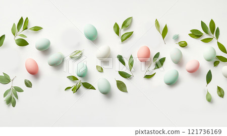 Charming arrangement of hand-painted pastel eggs and small bunny figurines scattered with fresh green leaves on a bright background for Easter 121736169
