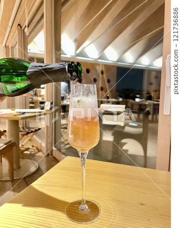 Pouring chapin into a glass Sparkling wine 121736886