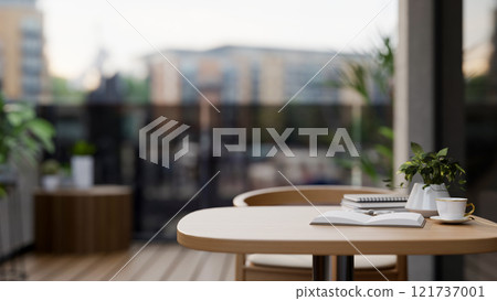 A close-up of a wooden table and armchair on a balcony of an apartment in the city. A close-up of a wooden table and armchair on a balcony of an apartment in the city. 121737001
