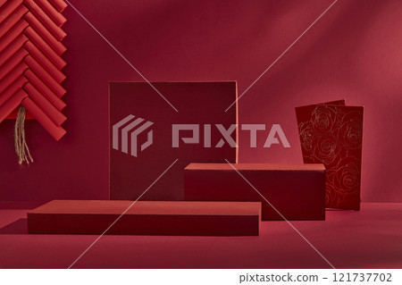 Chinese New Year design features a close-up of a few red platforms, set on a crimson backdrop, creating an empty space for product displays and decorated with a red lucky envelope and red firecrackers 121737702