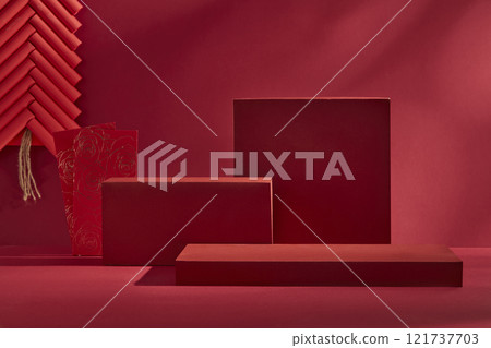 Against a crimson backdrop, a close-up angle of a few red platforms with an empty space for product displays, adorned with red firecrackers and red lucky envelopes. Perfect for a Chinese New Year idea 121737703