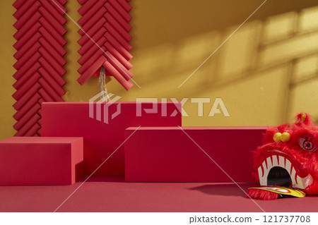 Three empty red platforms for product displays, decorated by a red lion dancing head, a paper fan, and strings of red firecrackers on a golden backdrop. Advertising photo with Chinese New Year theme. Three empty red platforms for product displays, decorated by a red lion dancing head, a paper fan, and strings of red firecrackers on a golden backdrop. Advertising photo with Chinese New Year theme. 121737708
