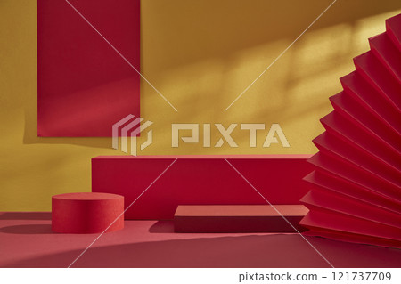 On a golden background, three empty red circular and rectangular platforms for product displays are decorated with red paper strings and a paper fan. An advertisement with a Chinese New Year design. On a golden background, three empty red circular and rectangular platforms for product displays are decorated with red paper strings and a paper fan. An advertisement with a Chinese New Year design. 121737709
