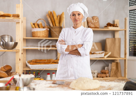Woman mixes liquid ingredients in bowl with whisk 121737891