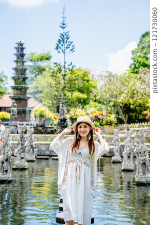 Bali, Indonesia - October 22, 2024: Girl in the pond of Tirta Gangga Water Palace, Bali, Indonesia. Bali, Indonesia - October 22, 2024: Girl in the pond of Tirta Gangga Water Palace, Bali, Indonesia. 121738060