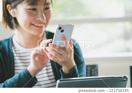 一位女士在旅途中使用數位產品 121738145