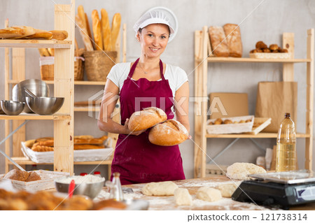 Adult woman with homemade bread in bakery Adult woman with homemade bread in bakery 121738314