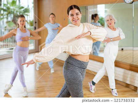 Dynamic young woman dancing hip-hop 121738332