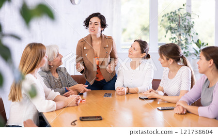 Hispanic woman discussing with group of female coursemates Hispanic woman discussing with group of female coursemates 121738604