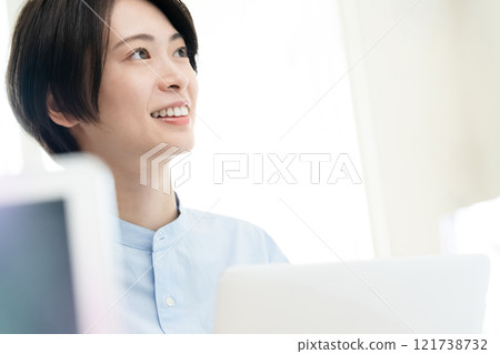 A young woman working on a computer in the office A young woman working on a computer in the office 121738732
