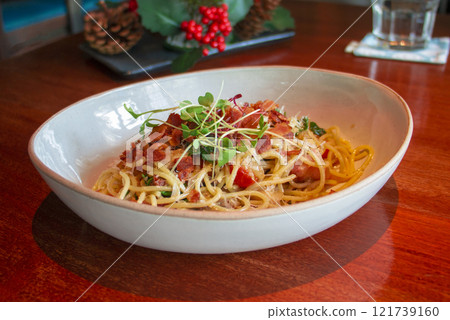 Spaghetti Carbonara in white bowl on table Spaghetti Carbonara in white bowl on table 121739160