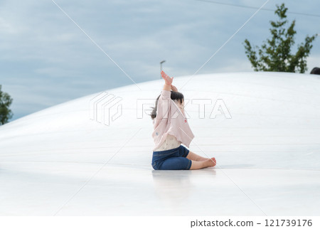 [Infants sitting on giant playground equipment] 121739176