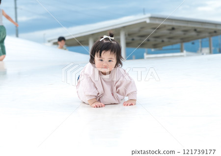 [Infants crawling on giant playground equipment] 121739177