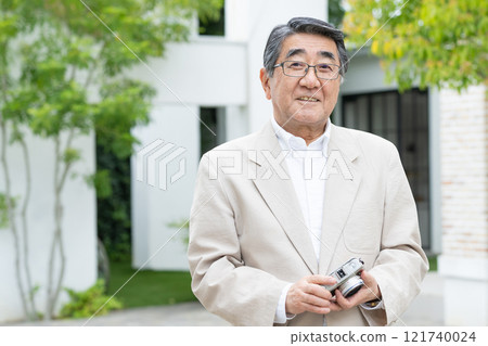 Senior male with camera 121740024