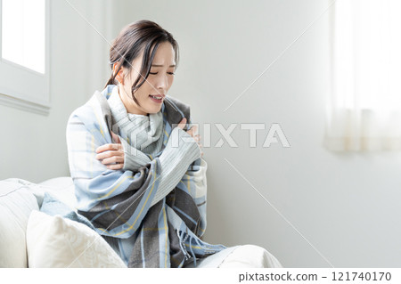A young woman who is sensitive to the cold, feeling unwell A young woman who is sensitive to the cold, feeling unwell 121740170