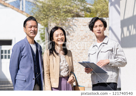 A businessman and a middle-aged couple having a meeting about renovation A businessman and a middle-aged couple having a meeting about renovation 121740540